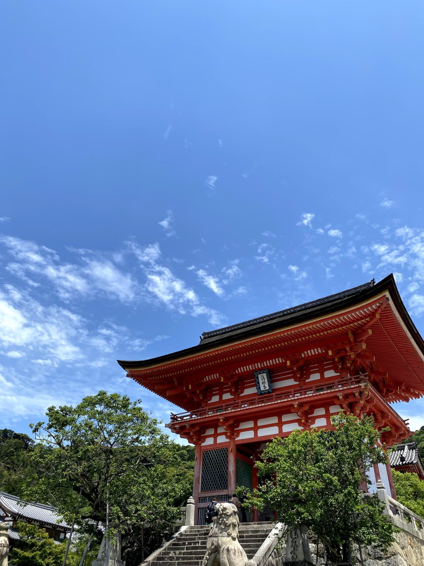 The vermilion Nio-mon gate of Kiyomizu-dera temple in Kyoto framed against a bright blue sky